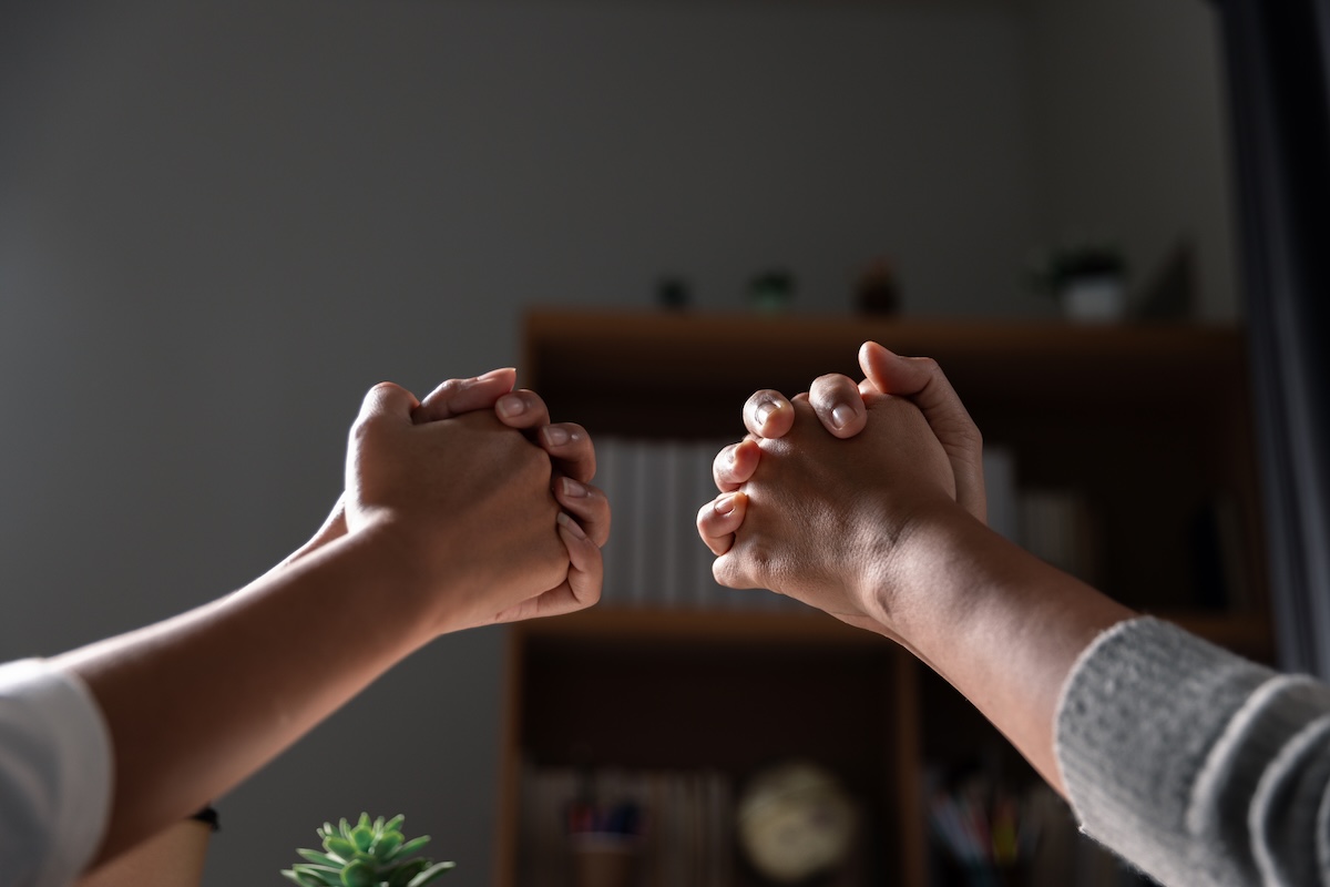 Group of different women praying together, Christians and Bible study concept.