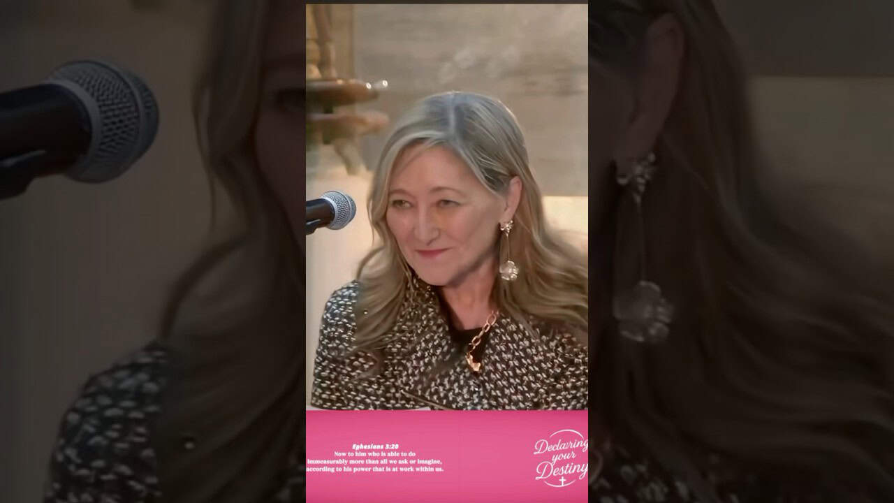 Woman speaking at Declaring Your Destiny International event, emphasizing wealth transfer and divine.